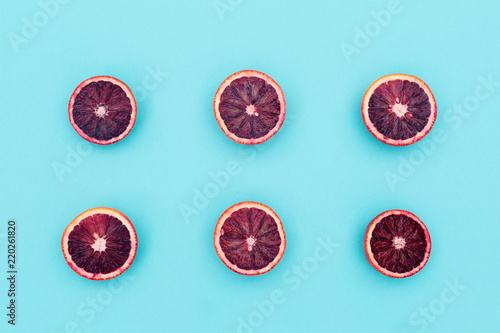 Red oranges on the bold blue background. Creative minimalism and modern food pattern concept