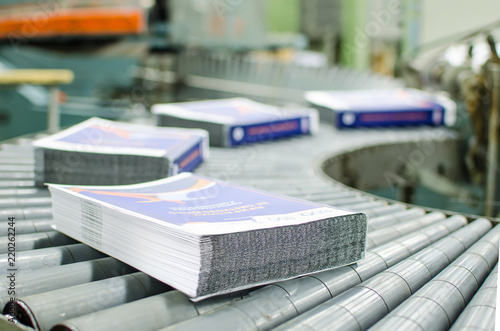 Print shop (press printing) - Finishing line. Post press finishing line machine: cutting, trimming, paperback and binding