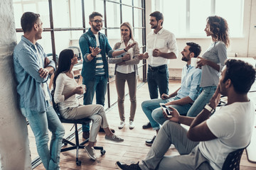 Group of young business people taking break in office
