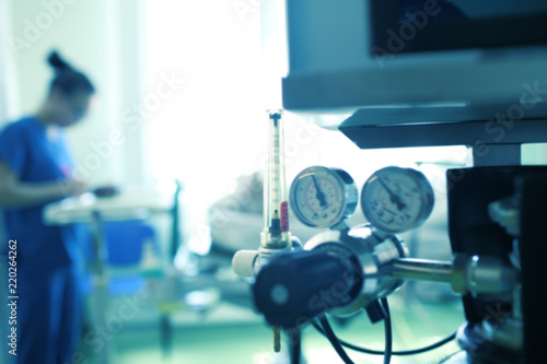 Photography Blurred silhouette of a female medical worker on the background of gas equipment