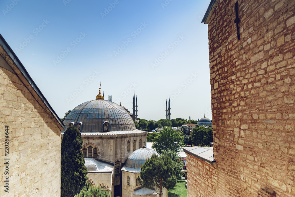 The Hagia Sophia Byzantine architecture domes with view of Blue Mosque (Sultanahmet Camii) at background, famous historic landmarks and world wonder in Istanbul, Turkey