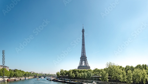 Panoramic view of Eiffel Tower and Seine river with puffy clouds, Paris, France