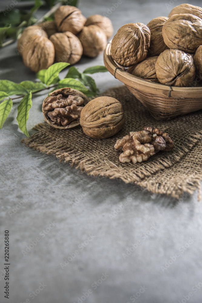 Walnuts in wooden bowl. Whole walnut on table Walnuts in wooden bowl. Whole walnut on table