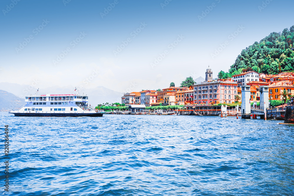 Lake Como, town Bellagio, Italy. Fascinating scenery of coastal town in famous and popular luxury summer resort - lake Como. Boat ferry in the distance.