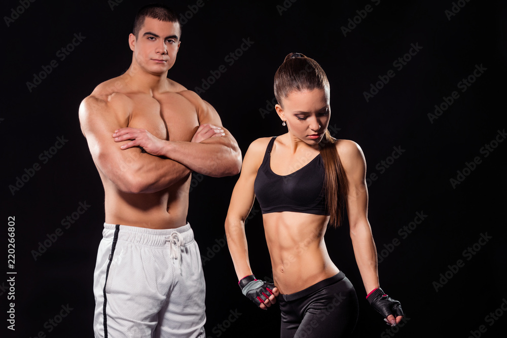 Fototapeta premium Fit couple showing muscles.