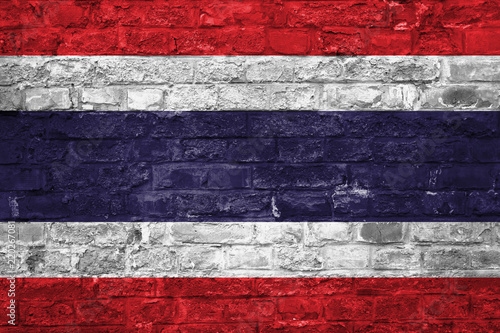 Flag of Thailand over an old brick wall background, surface