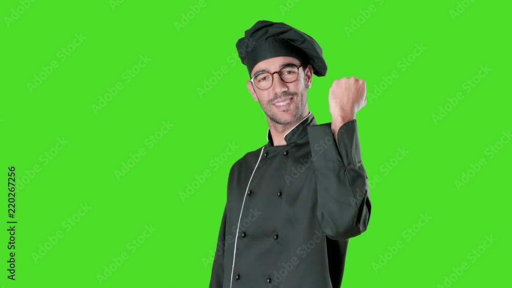 Confident young chef with a gesture of competition against green background Confident young chef with a gesture of competition against green background