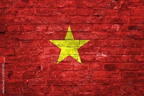 Flag of Vietnam over an old brick wall background, surface