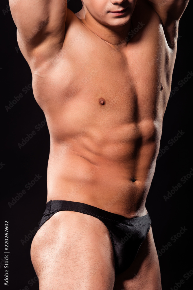 Athlete's abdominal muscle flexing pose.