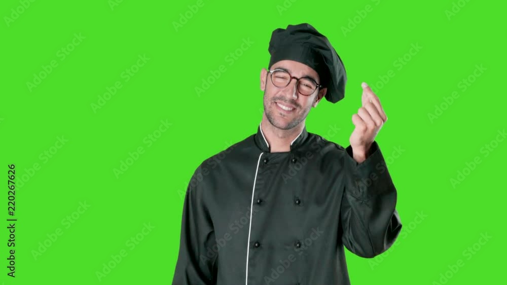 Concept of a confident young chef worried about his economy against green background Concept of a confident young chef worried about his economy against green background