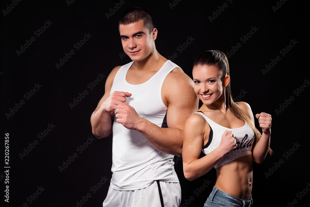 Fit couple smiling widely.