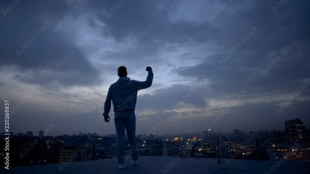 Winner man enjoying success on night cityscape background, personal leadership Winner man enjoying success on night cityscape background, personal leadership