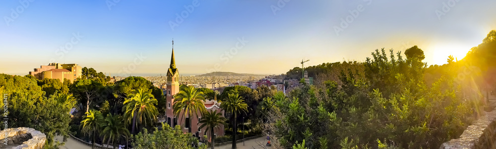 View of the city from Park Guell in Barcelona, Spain with sunrise colors