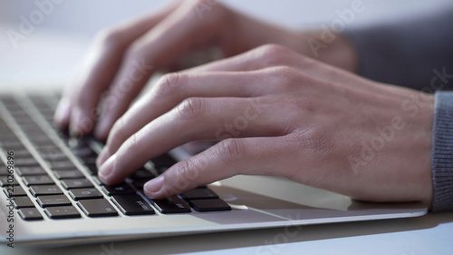 Journalist or writer typing text on laptop, using modern technologies for work