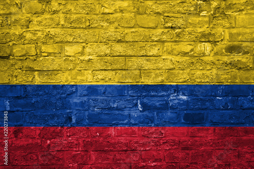Flag of Colombia over an old brick wall background, surface