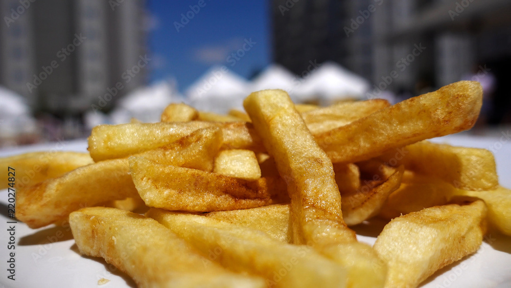Fried French potatoes are delivered by the waiter. Fried French potatoes are delivered by the waiter.