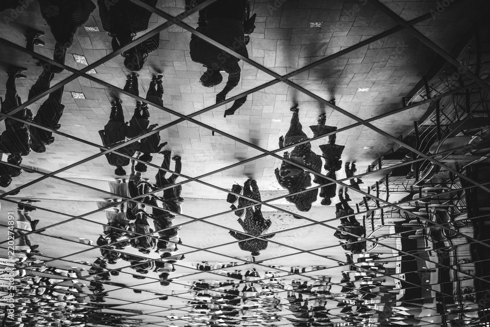 People silhouettes upside down walking