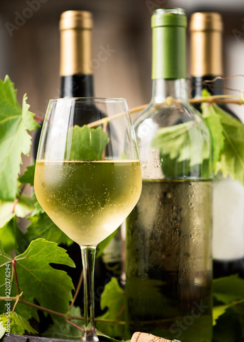 Glass of white wine on a barrel on white background