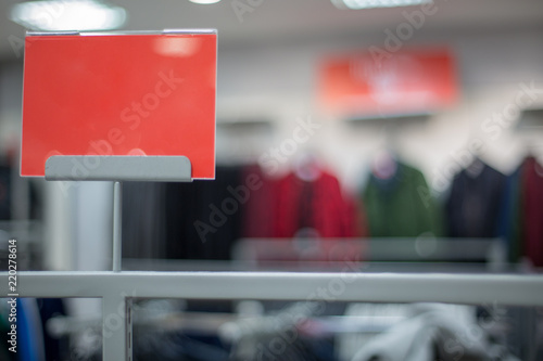 Red sign on a shop. Space for text. Sale in a clothing store. Copy space.