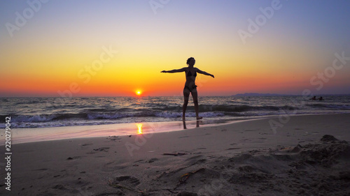 Fashion model woman walk out of ocean sunset water with hands wide open, FREEDOM CONCEPT, steadicam cinematic shot