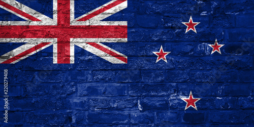 Flag of New Zealand over an old brick wall background, surface