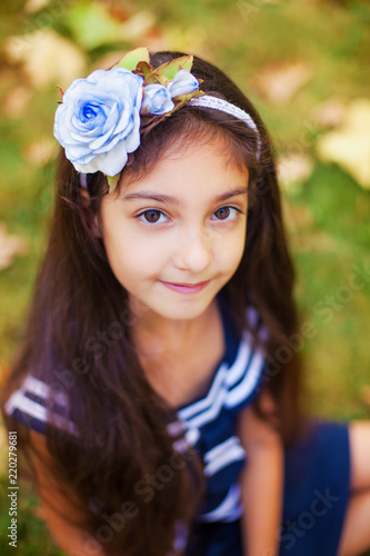 Portrait of little girl in autumn park