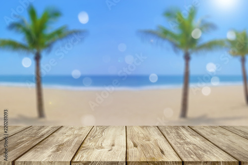 wooden table with blurred beach background