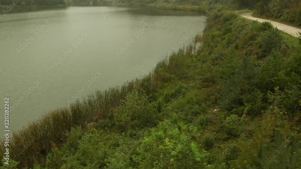 Aerial view of lake on mountain Goc in the fog. First signs of autumn, yellow ends on leaves. Mountain Goc - Serbia. Aerial view of lake on mountain Goc in the fog. First signs of autumn, yellow ends on leaves. Mountain Goc - Serbia.