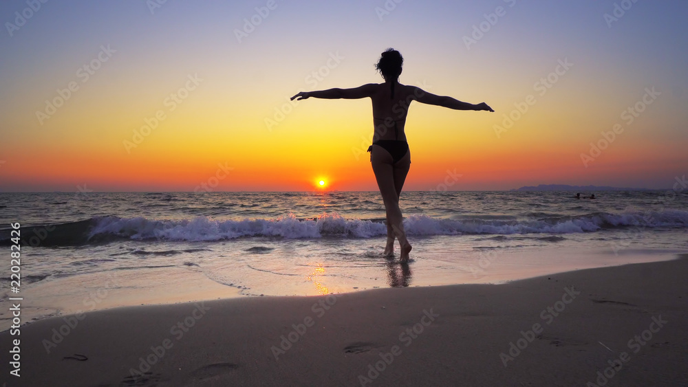 Fashion model woman walk into ocean sunset water with hands wide open, FREEDOM CONCEPT, steadicam cinematic shot