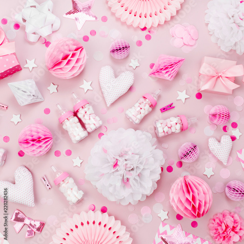 Pink and white Paper Decorations, pom-pom, candy, hearts, gifts, confetti for Baby party. Birthday concept. Flat lay, top view