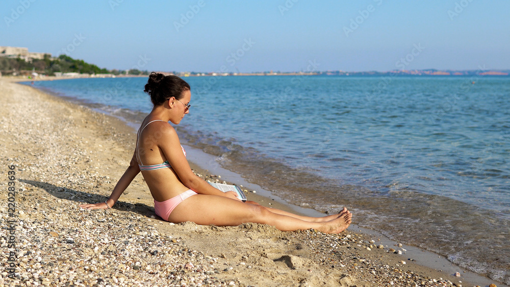 Teen fashion modelrelaxing on summer beach shore, cinematic view