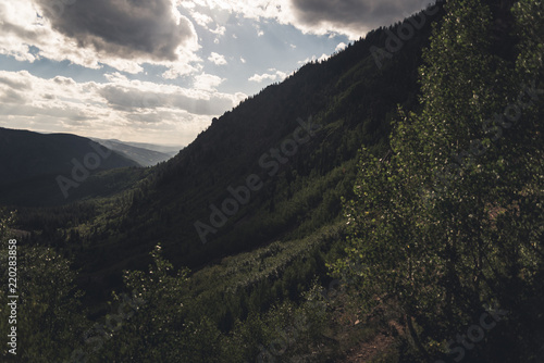 Landscape view with cloud shadows over a forested Valley near Vail  Colorado. 