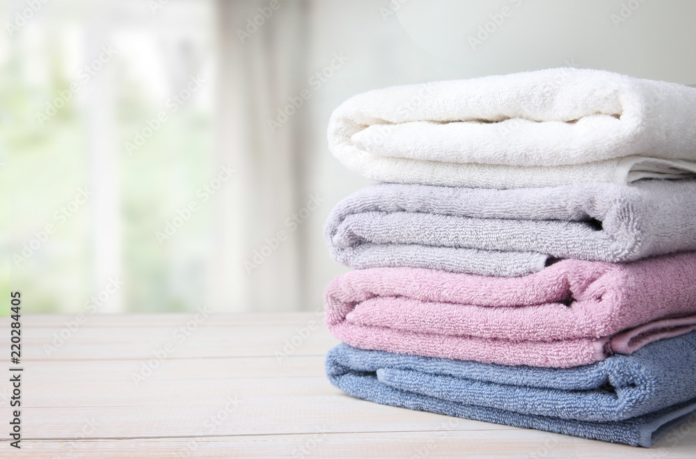 Towels stack on table empty space background. - obrazy, fototapety, plakaty 