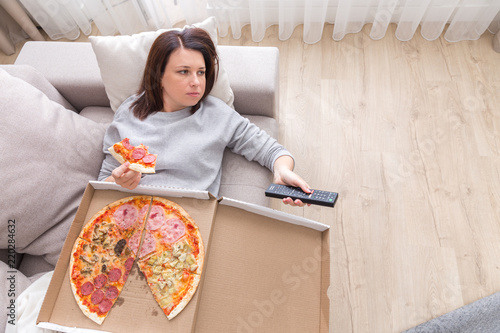 woman eating pizza image taken from above