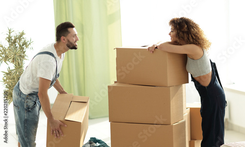 Young family unpacking boxes in a new house. © ASDF