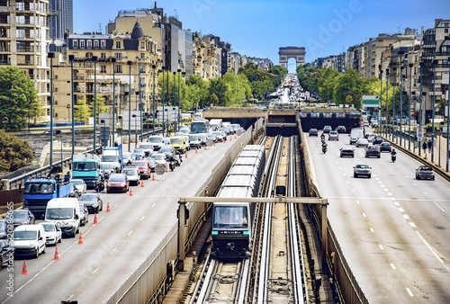 Paris traffic with roadworks viewed from La Defense toward Arc De Triomphe, car vehicles, metro train rush hour