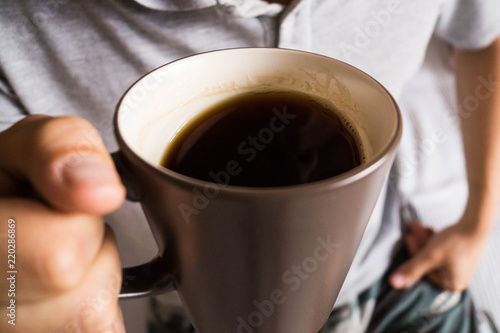 The man drinking black coffee at home