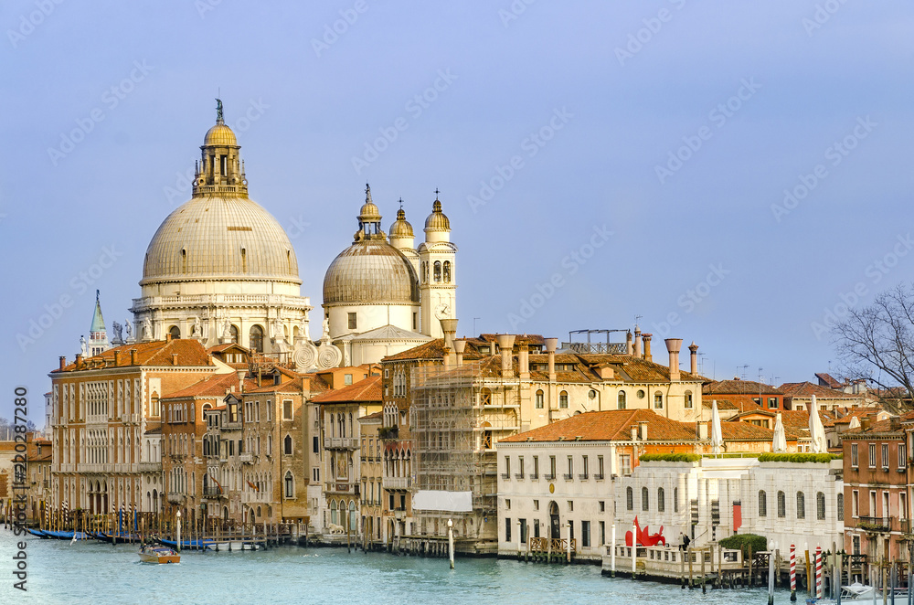 Gorgeous view of Basilica Santa Maria della Salute and traditional architecture during sunset, Venice, Italy