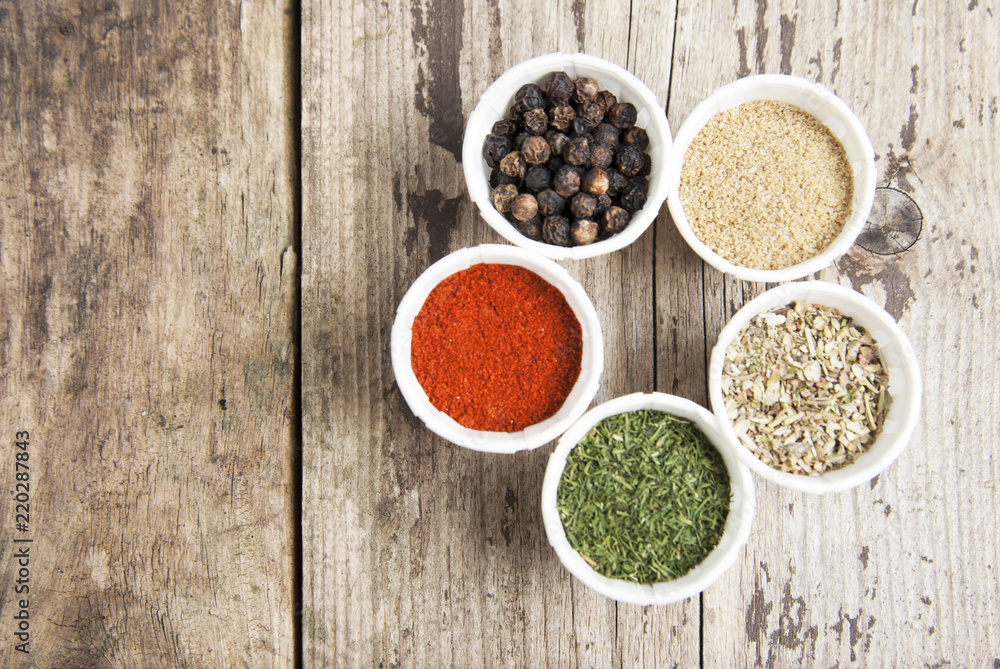 Various spices on wooden rustic background: rosemary, paprika, black pepper. Top view. Copy space. Various spices on wooden rustic background: rosemary, paprika, black pepper. Top view. Copy space.