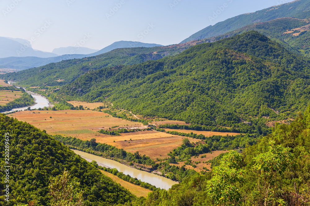 Scenic landscape view in Melesin mountain in summer day. In the valley, view of the river Viosa. Leskovik area, Albania, Europe. Scenic landscape view in Melesin mountain in summer day. In the valley, view of the river Viosa. Leskovik area, Albania, Europe.