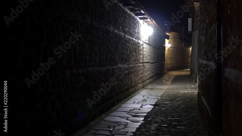 A Narrow Dark Horror Street at Night in Europe