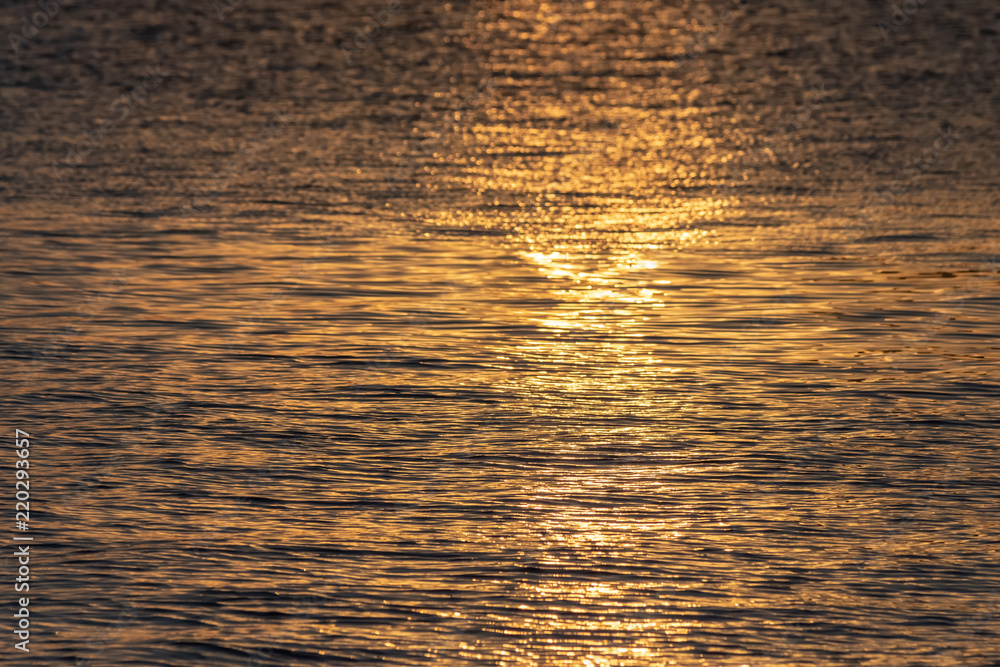 Beautiful texture of the golden sea at sunset