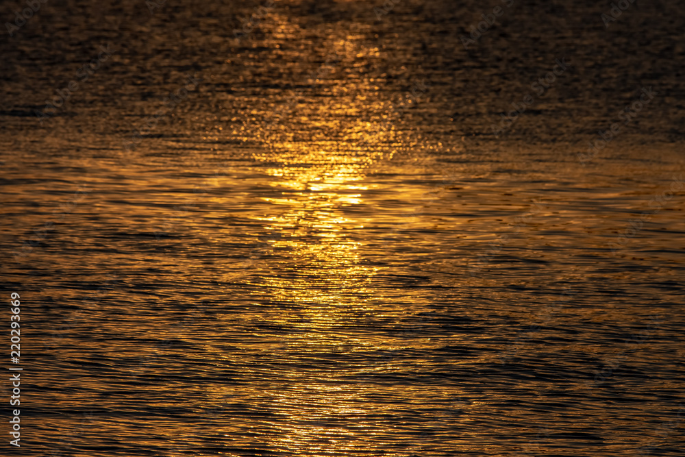 Beautiful texture of the golden sea at sunset