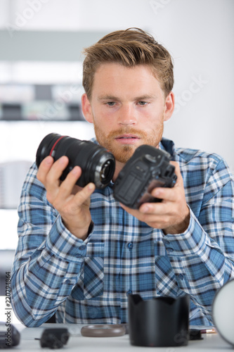professional photographer assembling camera © auremar