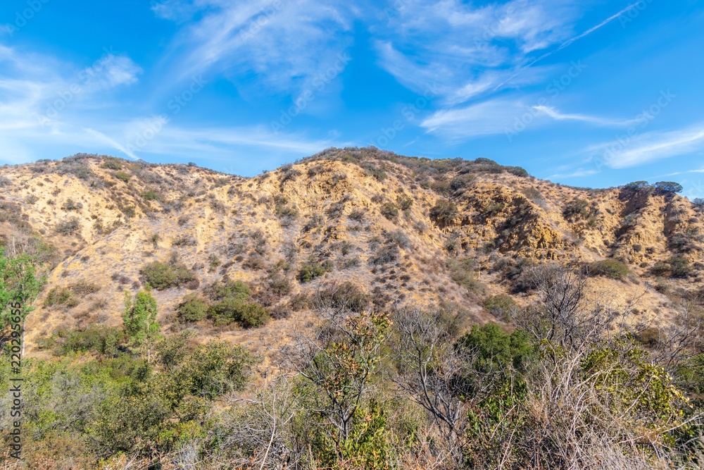 Rocky hillsides in California desert mountains on hot summer afternoon with room for text in sky Rocky hillsides in California desert mountains on hot summer afternoon with room for text in sky