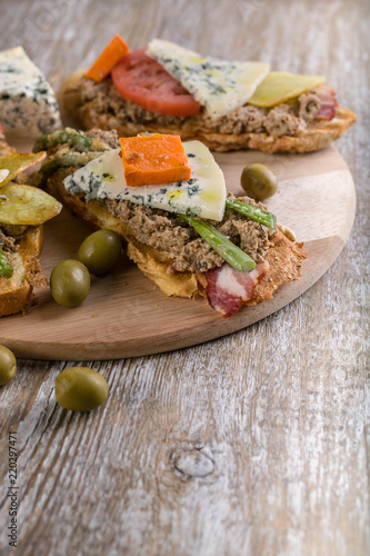 Italian sandwiches with mushroom pate, vegetables and cheese. Mediterranean traditional cuisine. Vertical shot