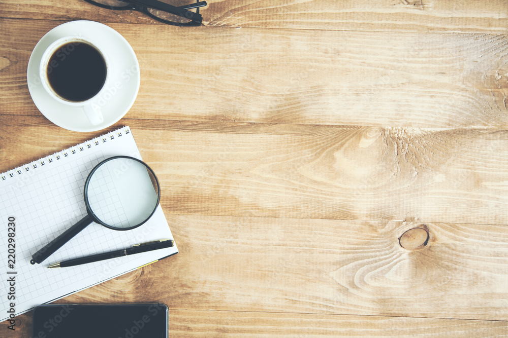 magnifier on notepad with coffee magnifier on notepad with coffee