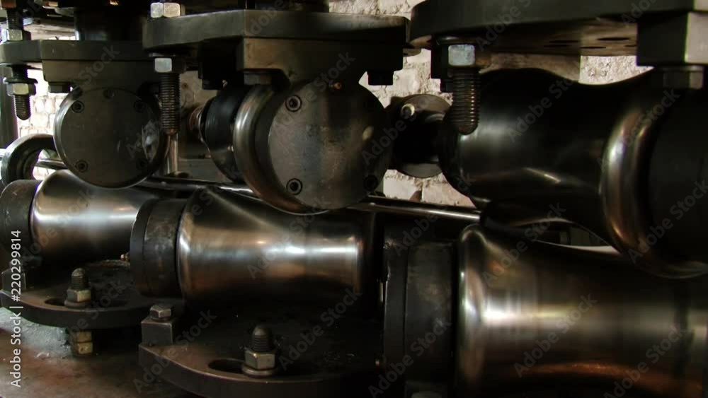 Close-up of metal-rolling machines for production metal steel pipes in factory. Seamless technology for production of profile pipe. Close-up of metal-rolling machines for production metal steel pipes in factory. Seamless technology for production of profile pipe.