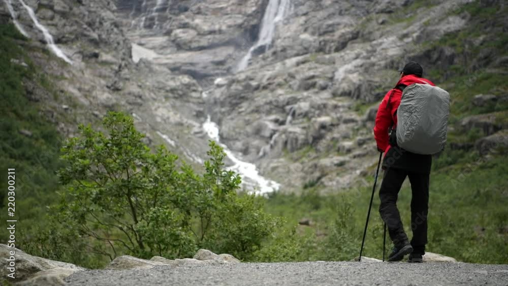 Caucasian Men Backpacking on Norwegian Glacier Trail. Caucasian Men Backpacking on Norwegian Glacier Trail.