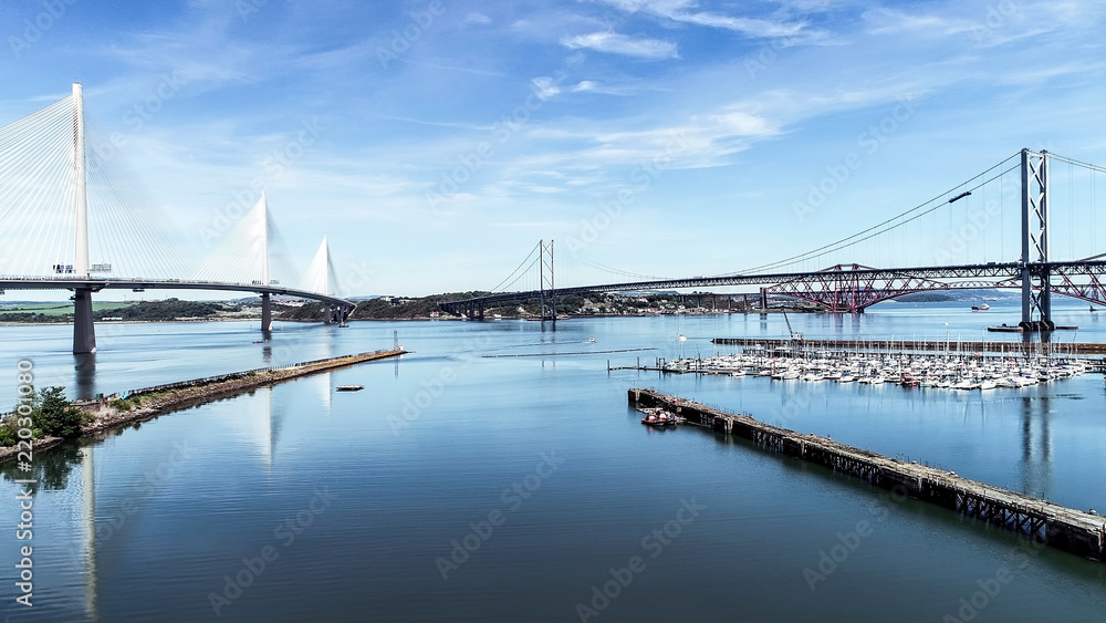 Aerial image looking over the marina at South Queensferry to the Forth road and rail bridge and new Queensferry Crossing.